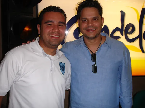 Nelson Vahos frente al logo de Candela Estéreo
